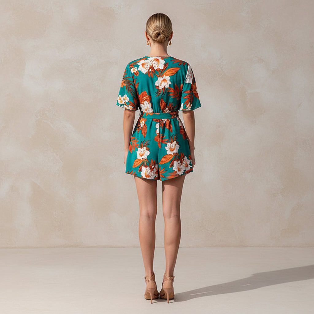 Woman wearing a floral romper on a beach