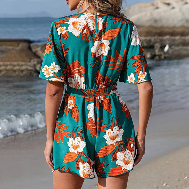 Woman wearing a floral romper on a beach