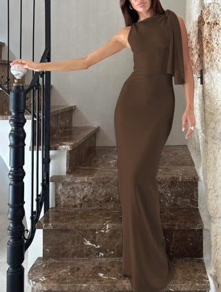 Woman in a brown dress standing on a staircase