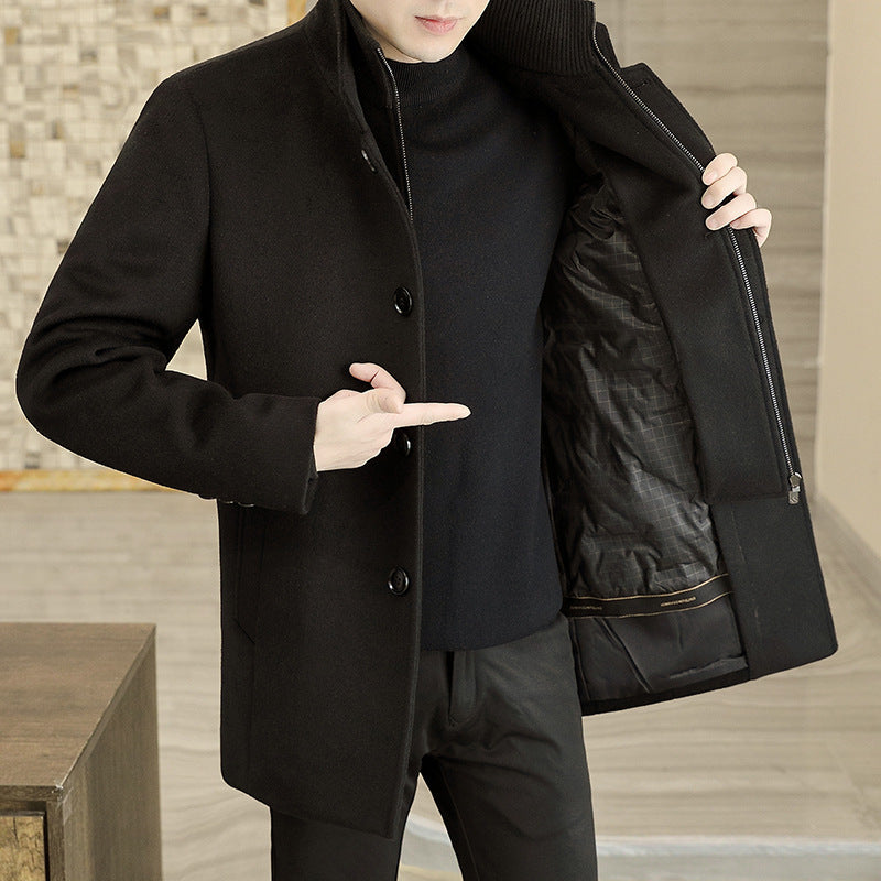 Person wearing a black coat with a textured background