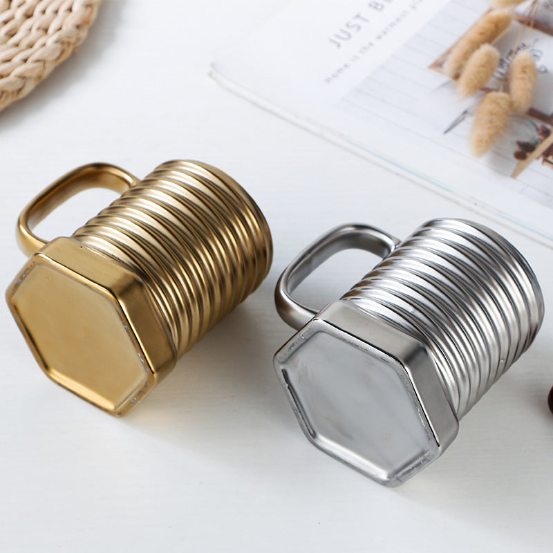 Gold and silver hexagonal bottle stoppers on a white surface with a magazine in the background.