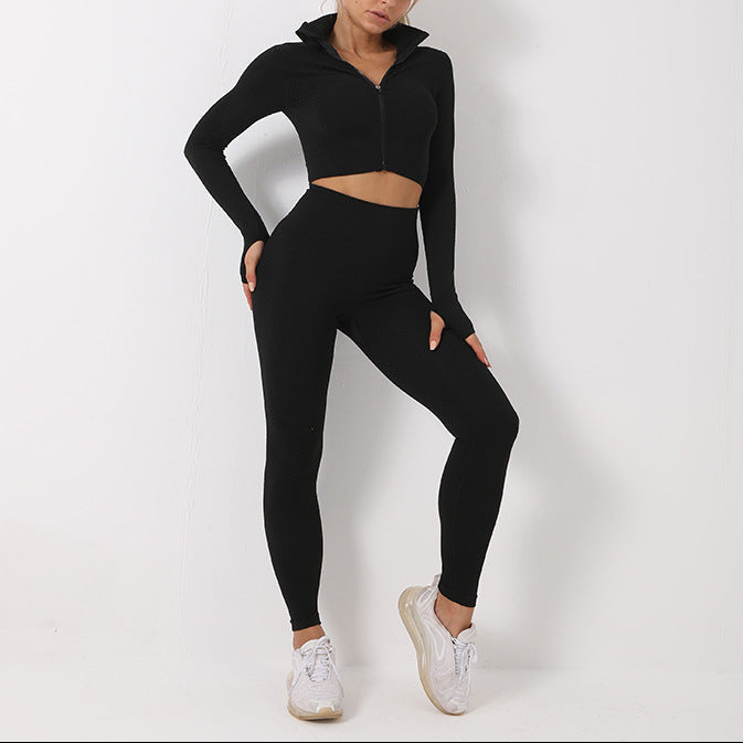 Woman wearing a black athletic outfit on a white background