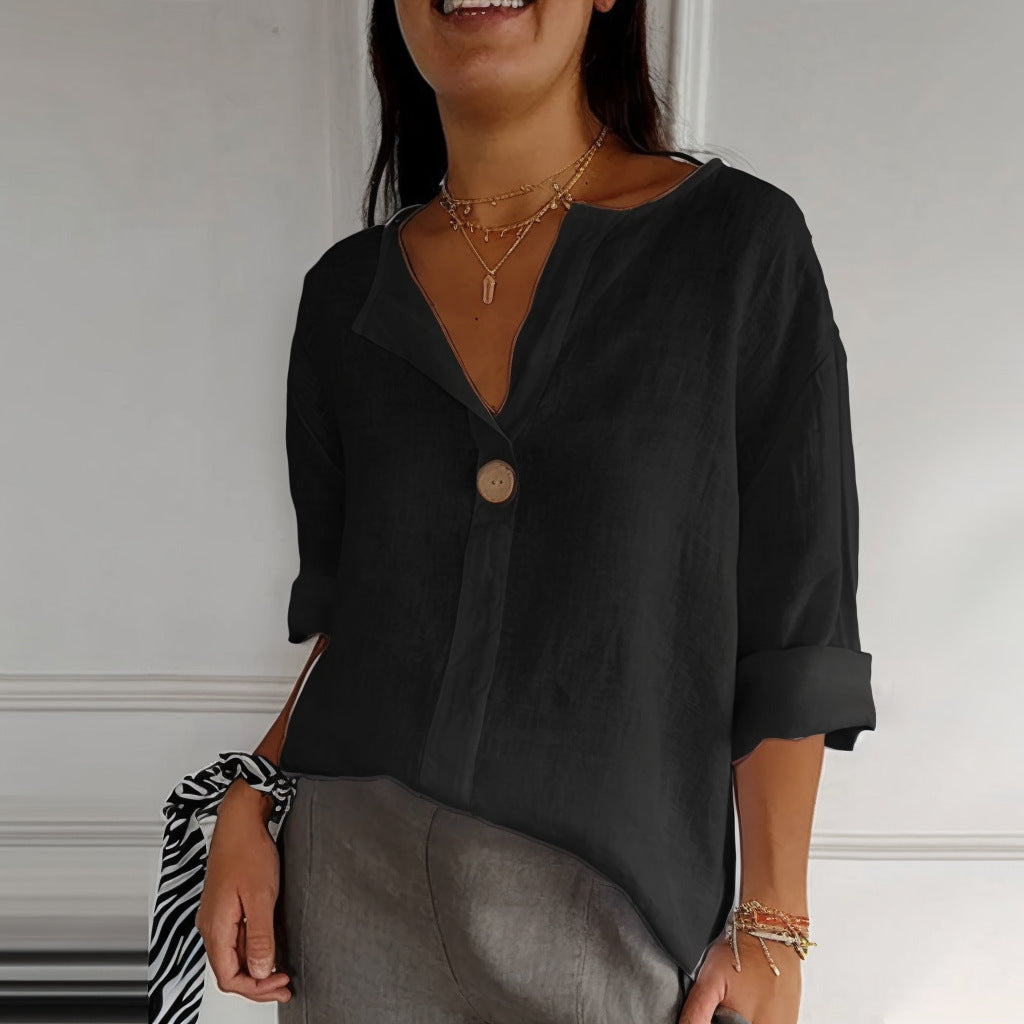 Woman wearing a black blouse with a neutral background