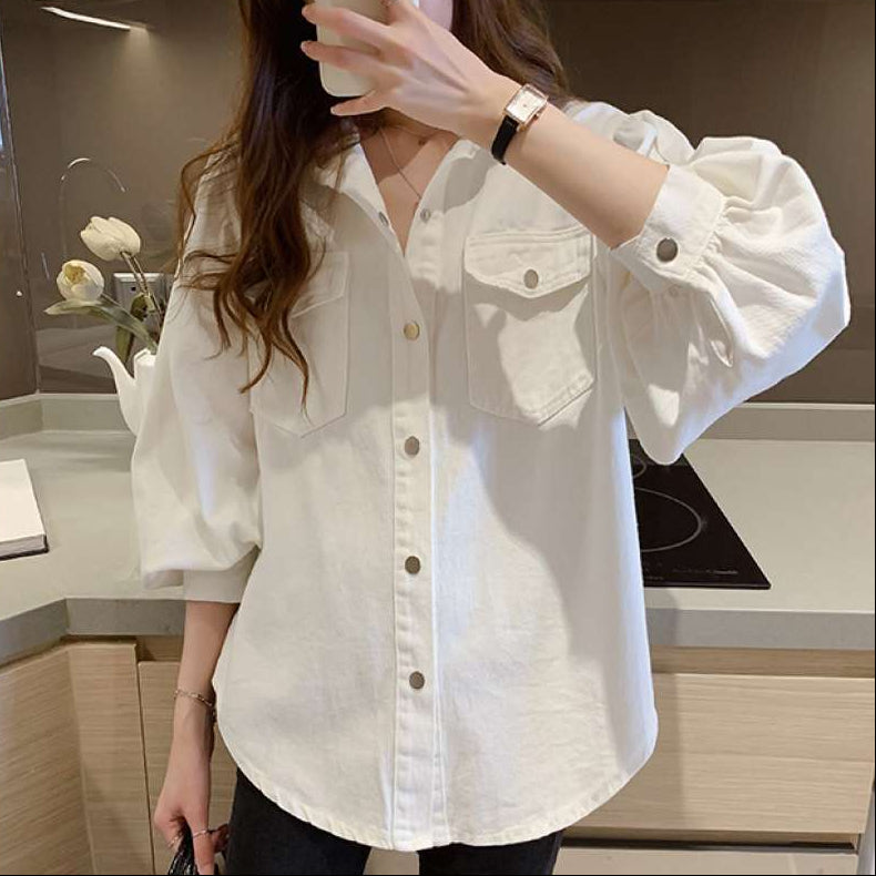 Person wearing a white denim shirt in a kitchen setting