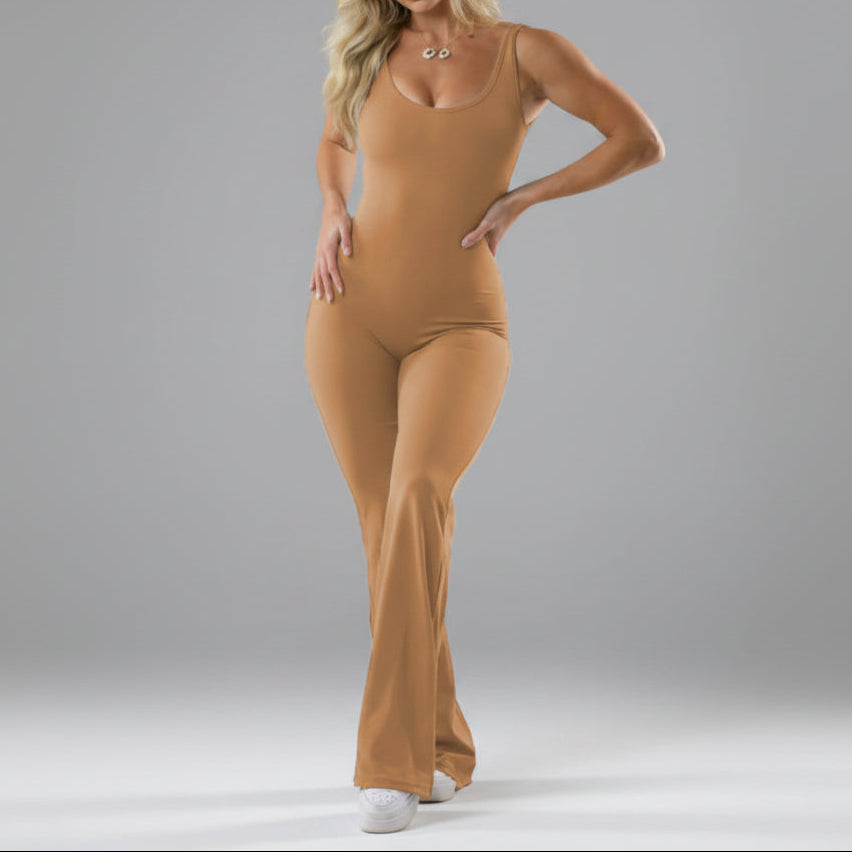 Woman wearing a beige bodysuit against a gray background