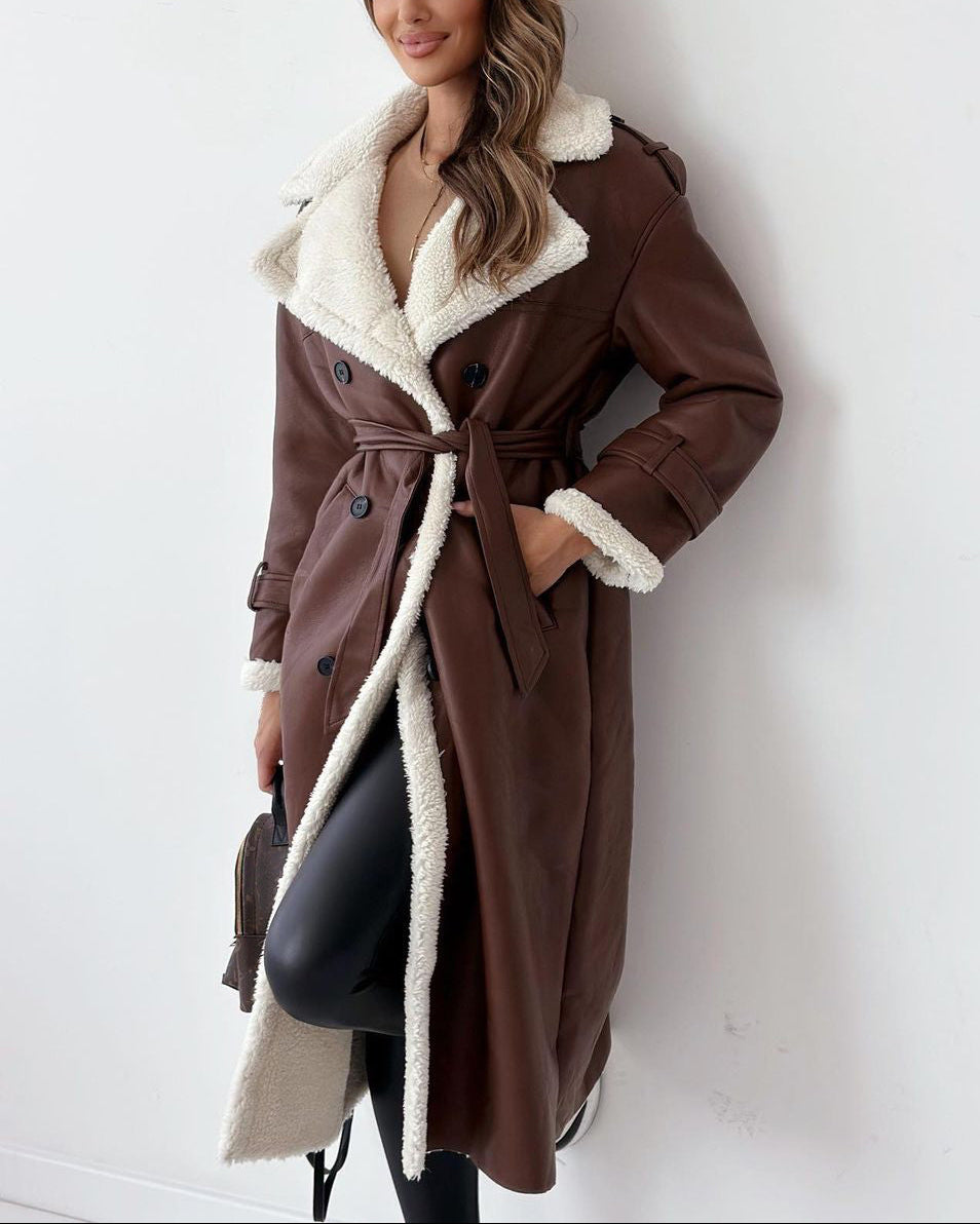 Woman wearing a brown coat with white fur lining against a white background