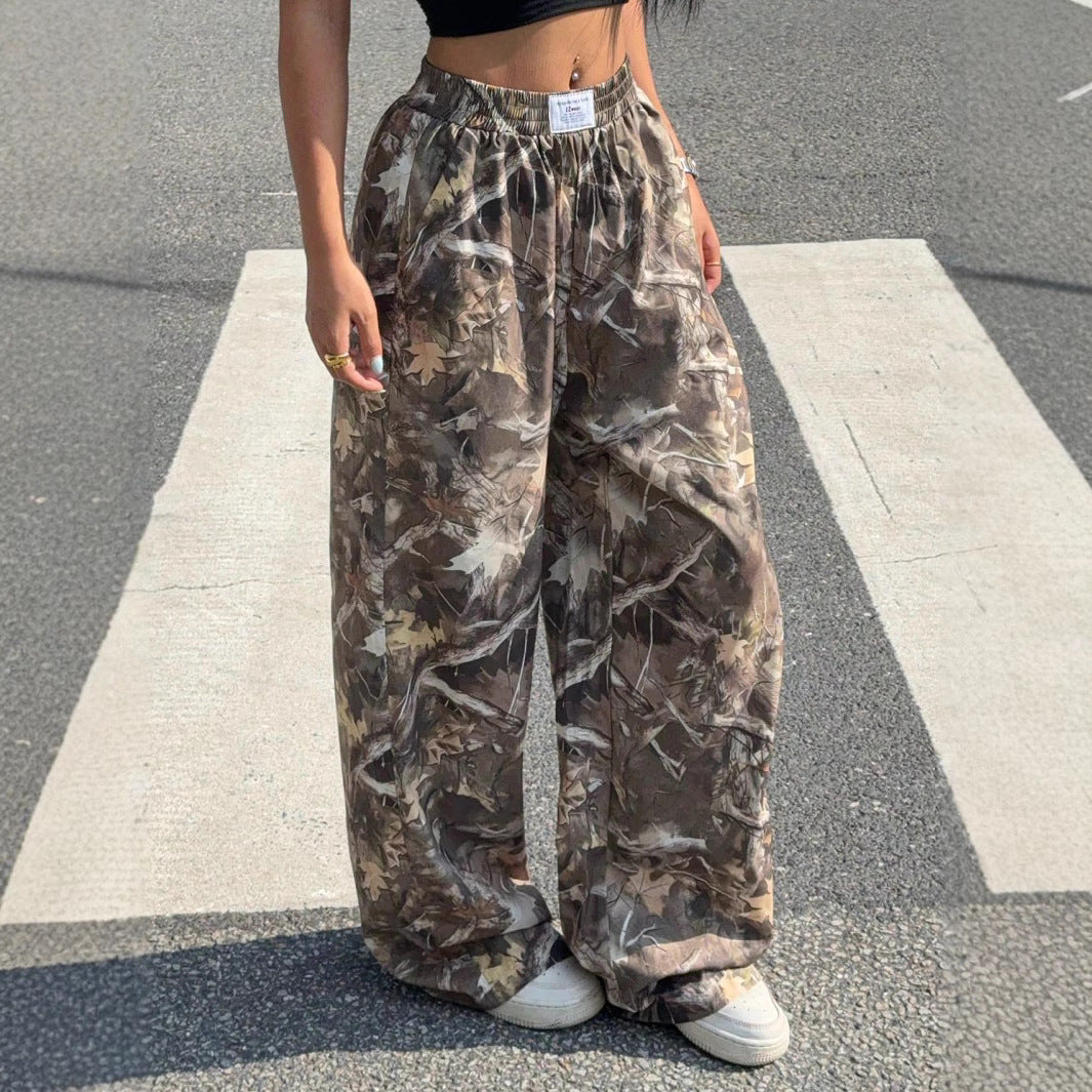 Person wearing camouflage pants standing on a crosswalk