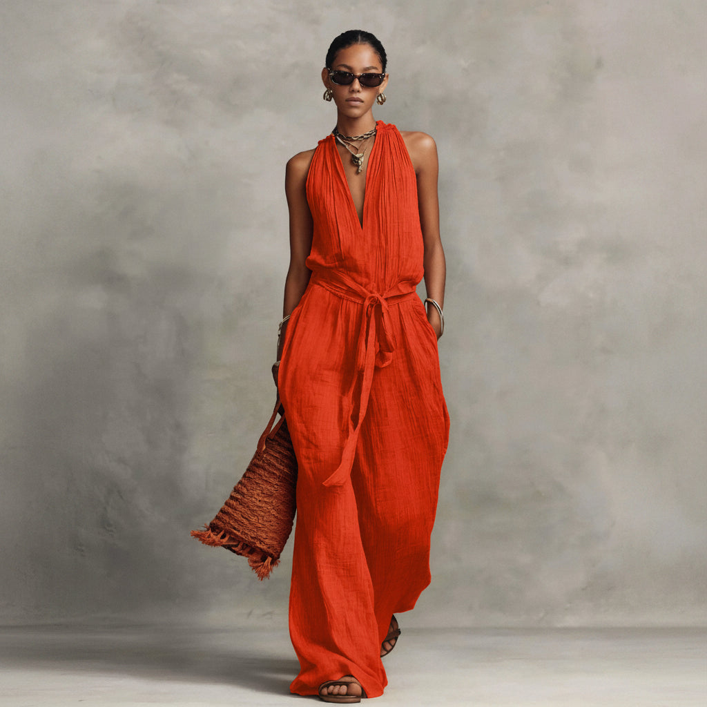 Woman wearing a red jumpsuit against a gray background