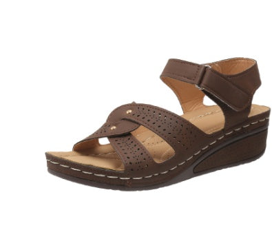 Brown sandal with a wedge sole on a white background
