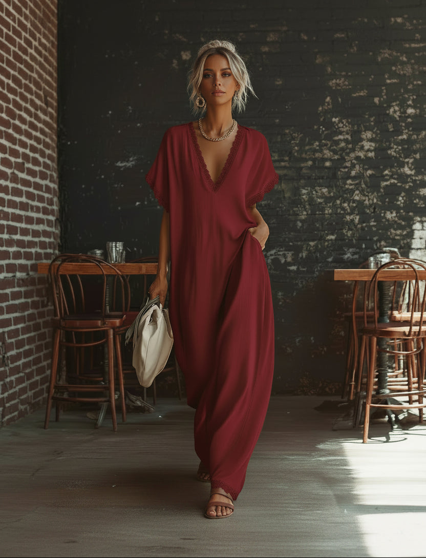 Person wearing a red dress standing in a dimly lit room with wooden furniture.