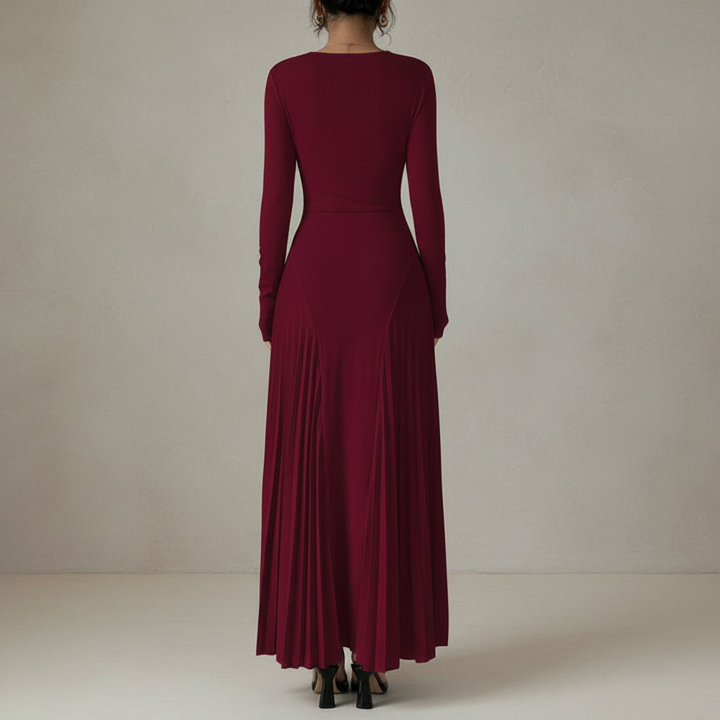 Maroon long-sleeve dress with a pleated skirt on a neutral background