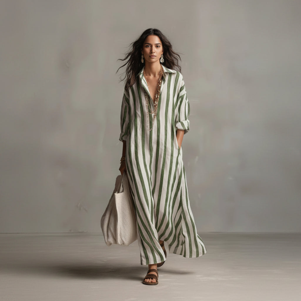 Woman wearing a green and white striped dress against a plain background