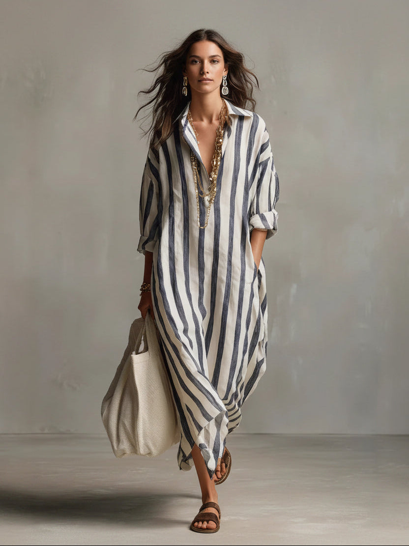 Woman wearing a long, striped dress against a neutral background