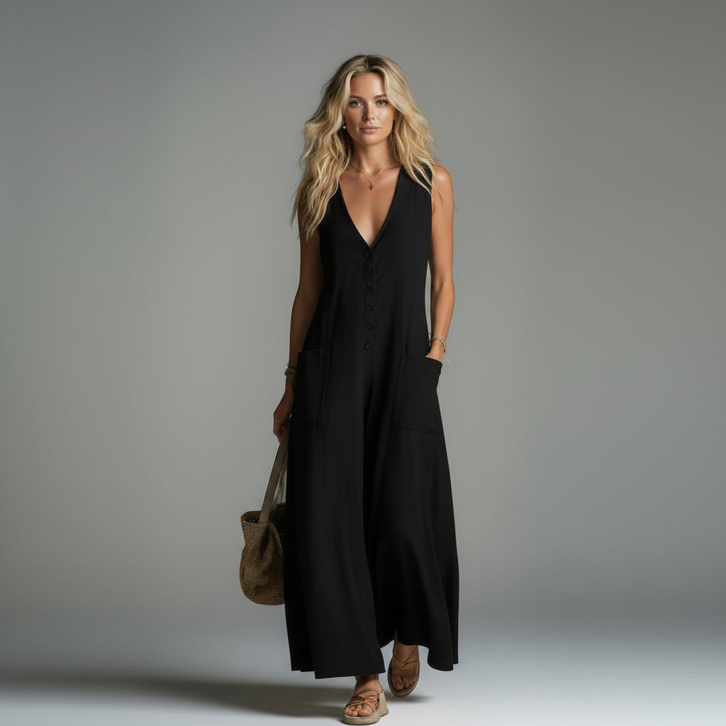 Woman wearing a black sleeveless dress against a gray background
