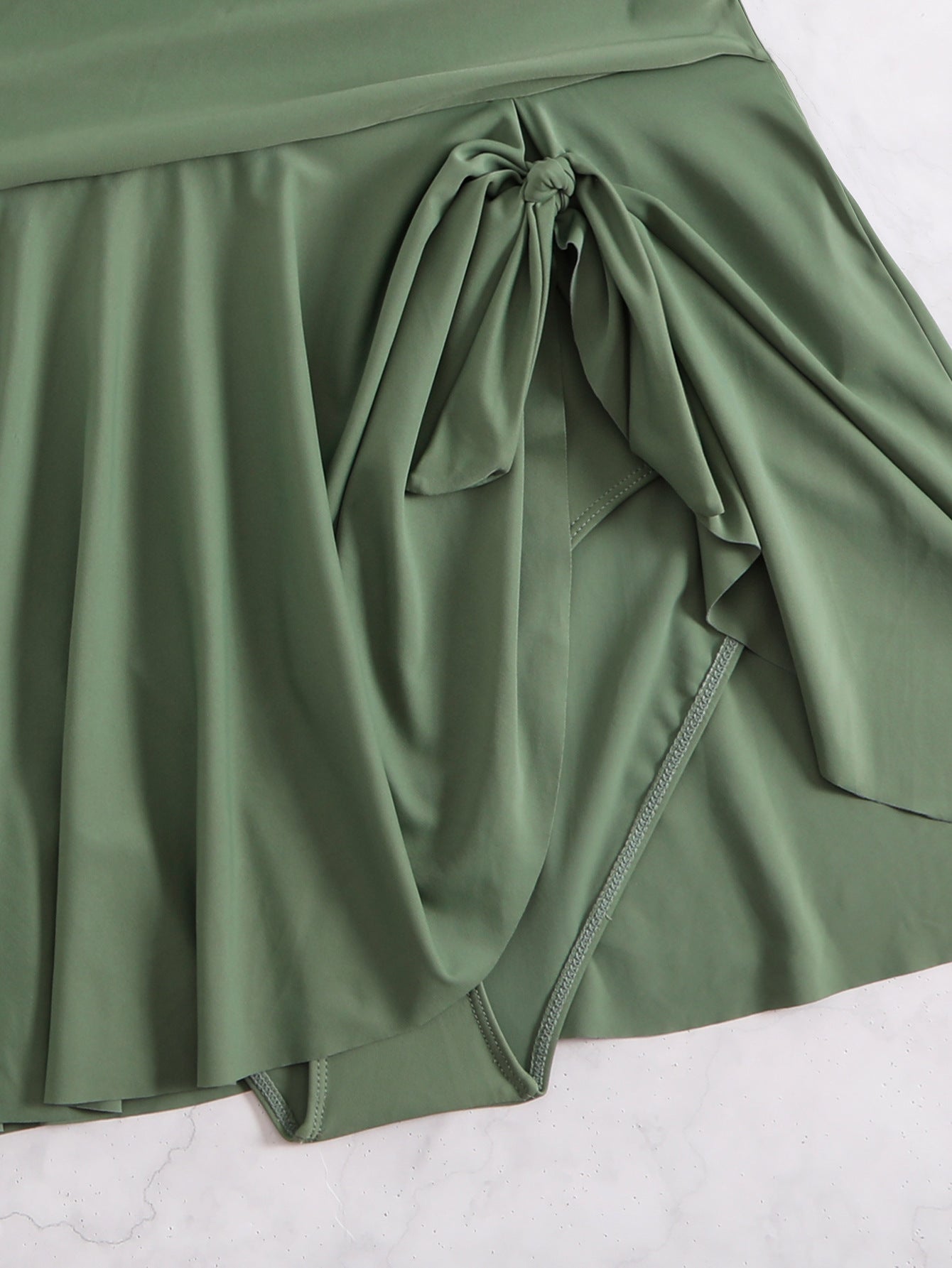 Green skirt with a tie detail on a white background