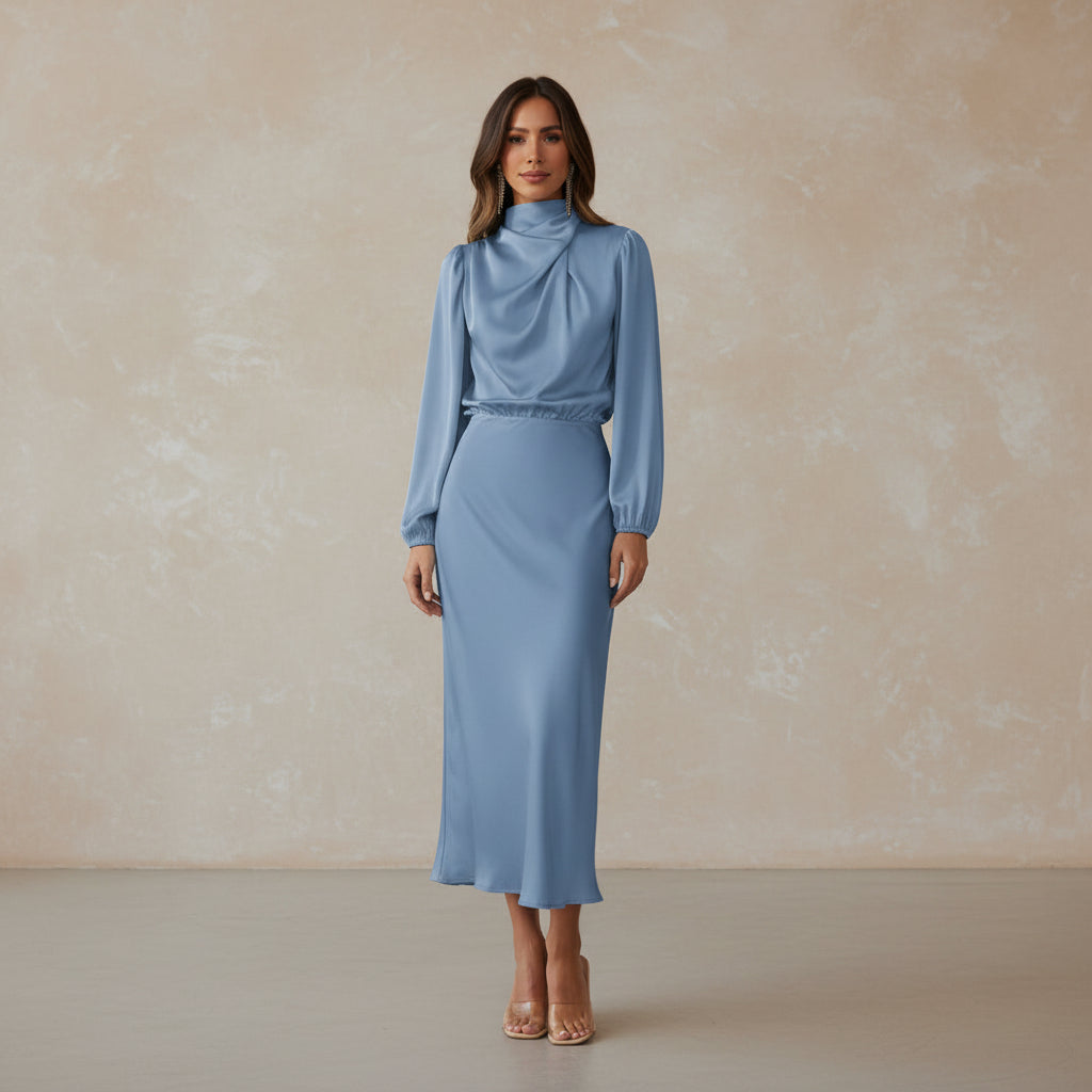 Woman wearing a light blue outfit in a minimalistic setting