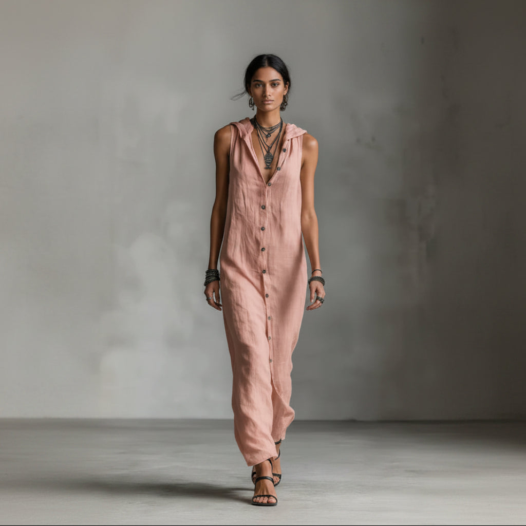 Person wearing a pink sleeveless jumpsuit against a gray background