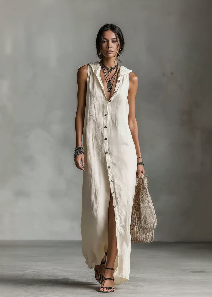 Woman wearing a long beige dress with a neutral background