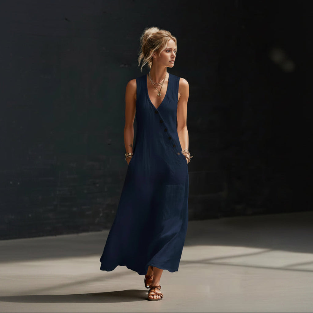 Woman wearing a navy blue dress against a dark background