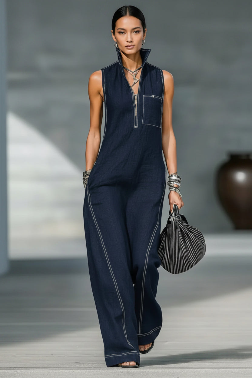 Person wearing a navy blue jumpsuit with a blurred background