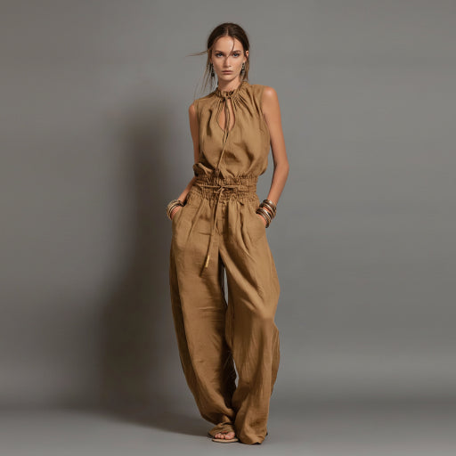 Woman wearing a brown jumpsuit against a gray background