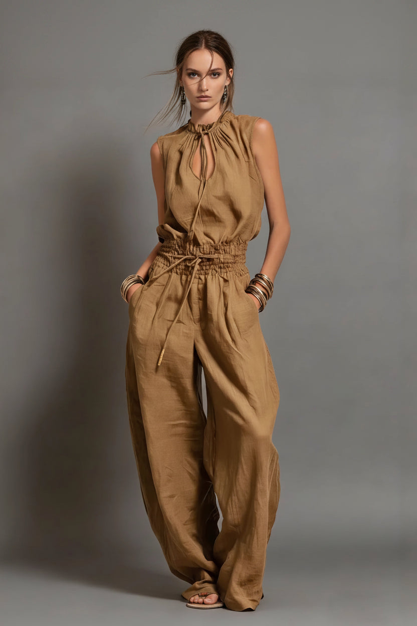 Woman wearing a brown jumpsuit against a gray background