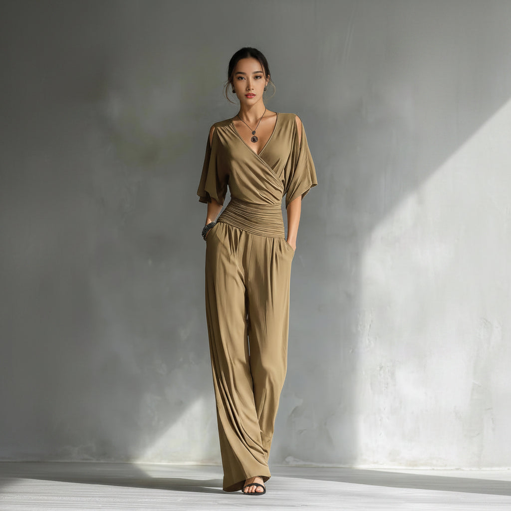 Woman wearing a beige jumpsuit against a gray background
