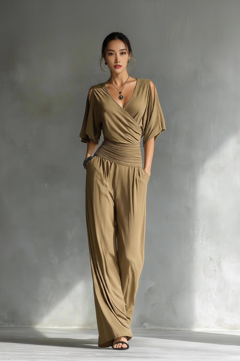Woman wearing a beige jumpsuit against a gray background