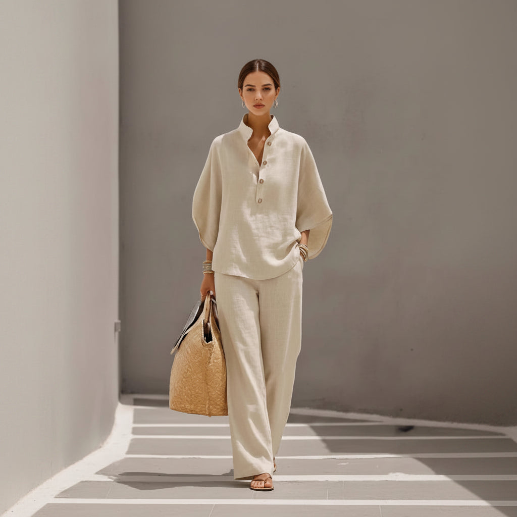 Person wearing a beige outfit holding a woven bag against a neutral background