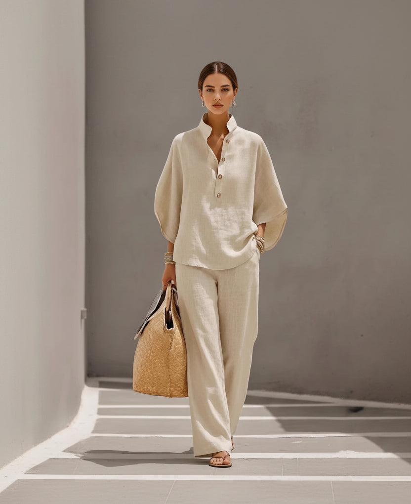 Person wearing a beige outfit holding a woven bag against a neutral background