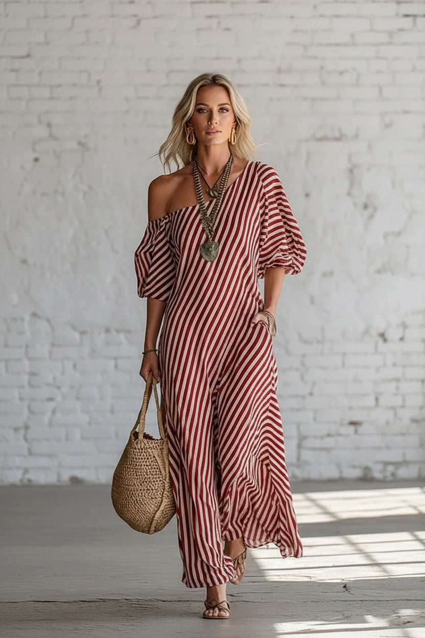 Woman wearing a red and white striped dress with a textured wall background