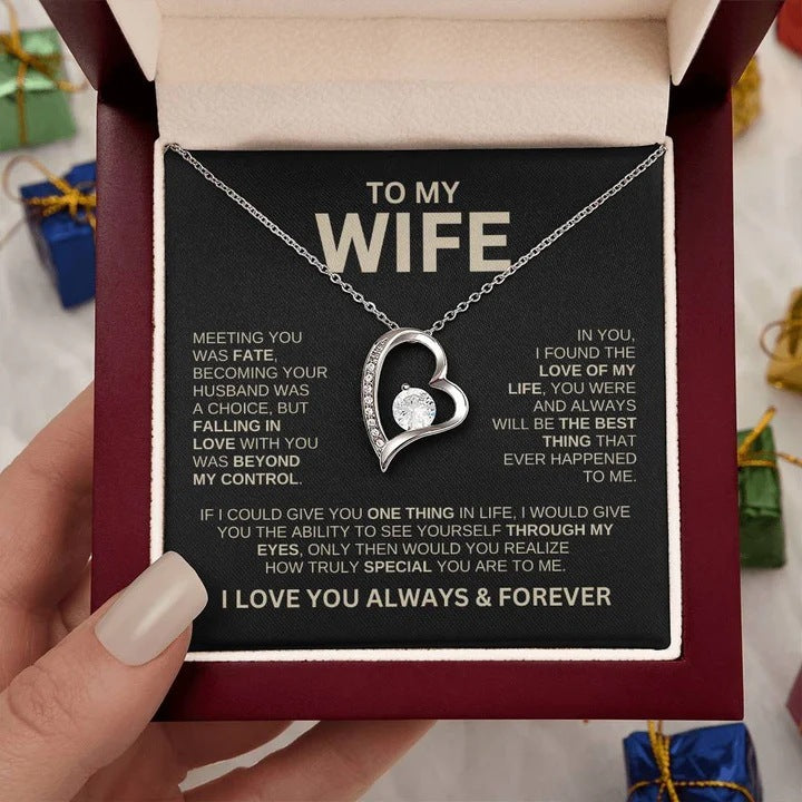 Heart-shaped necklace in a box with a sentimental message for a wife.