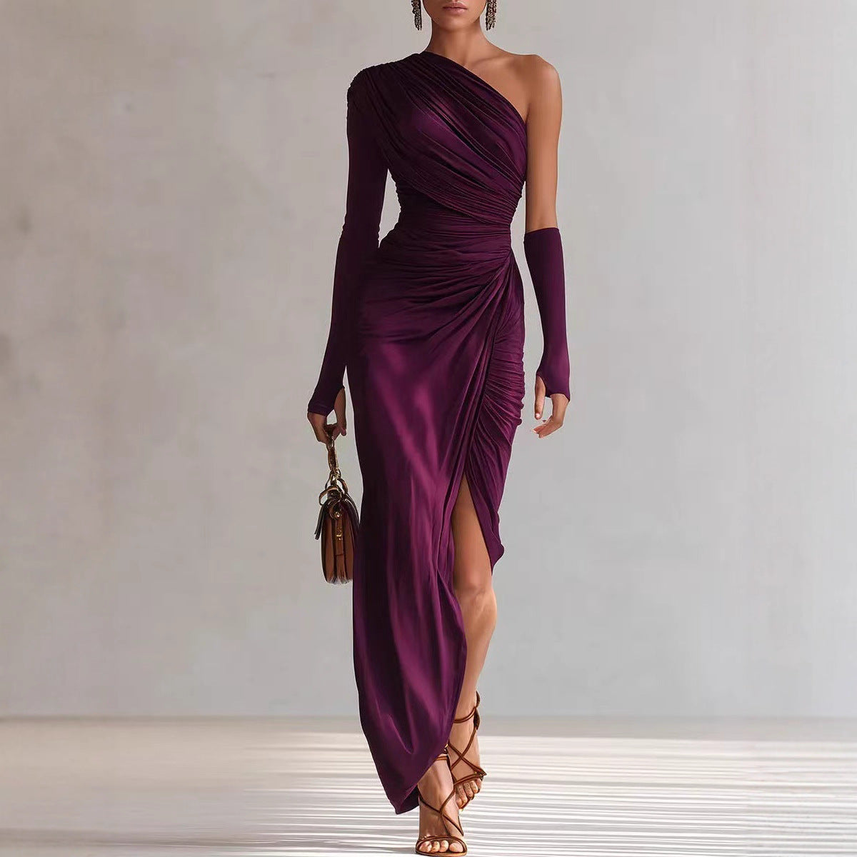 Woman wearing a purple one-shoulder dress with a slit, holding a brown handbag against a neutral background.