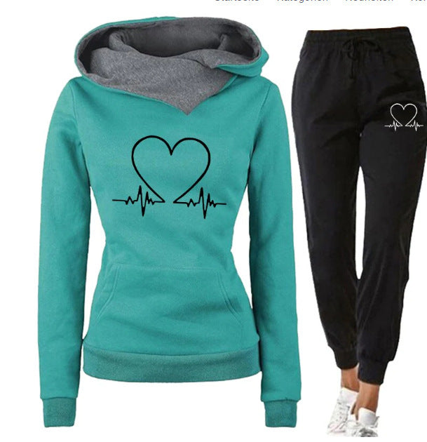 Teal hoodie with heart design and black pants on a white background