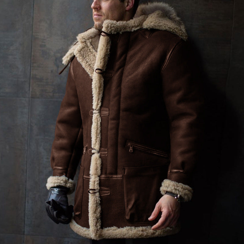 Man wearing a brown shearling coat against a dark background
