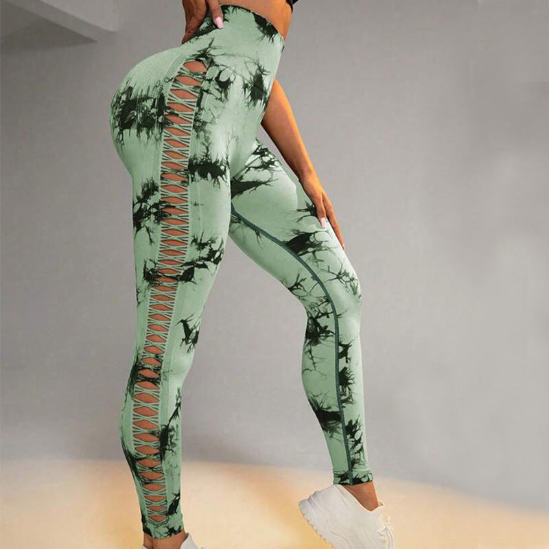 Green tie-dye leggings with cut-out design on a neutral background