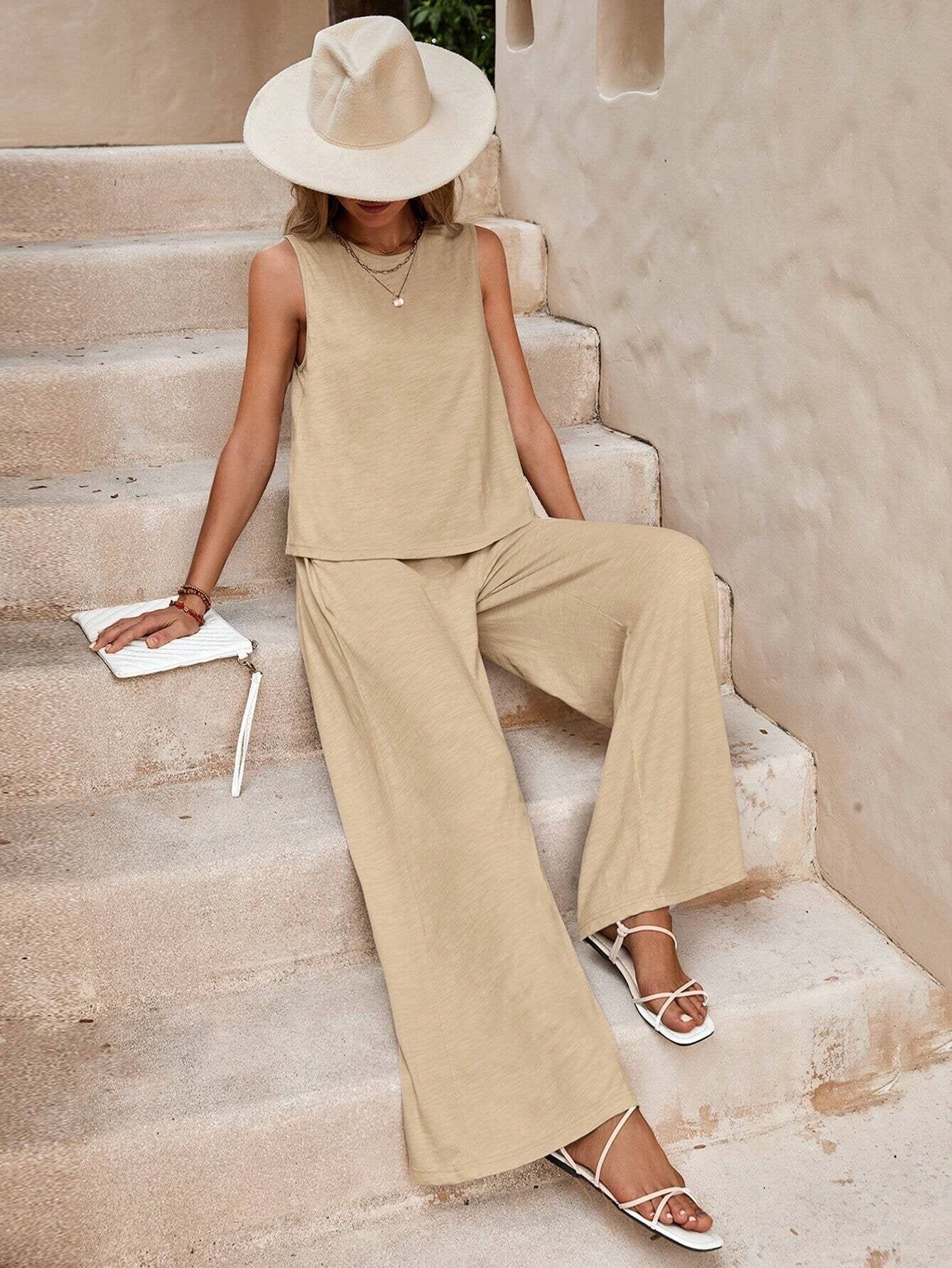 Woman in beige outfit sitting on stone steps