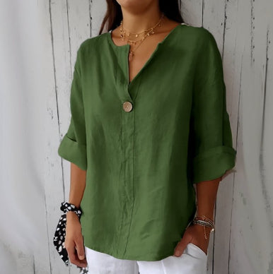 Person wearing a green shirt against a white wooden panel background