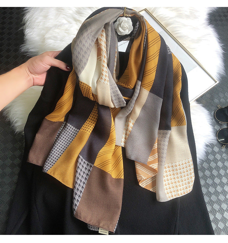 Patterned scarf draped over a person, with a blurred background