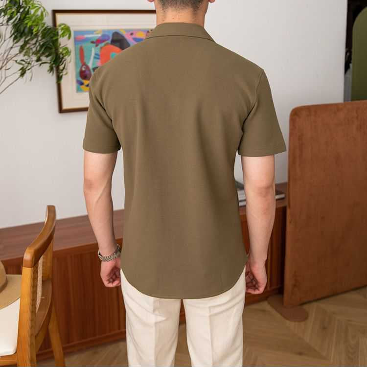 Man wearing a brown polo shirt in an indoor setting