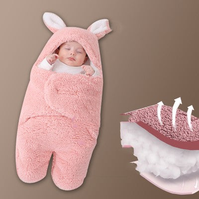 Baby wrapped in a pink bunny-style sleeping bag with a close-up of the soft interior on a brown background.