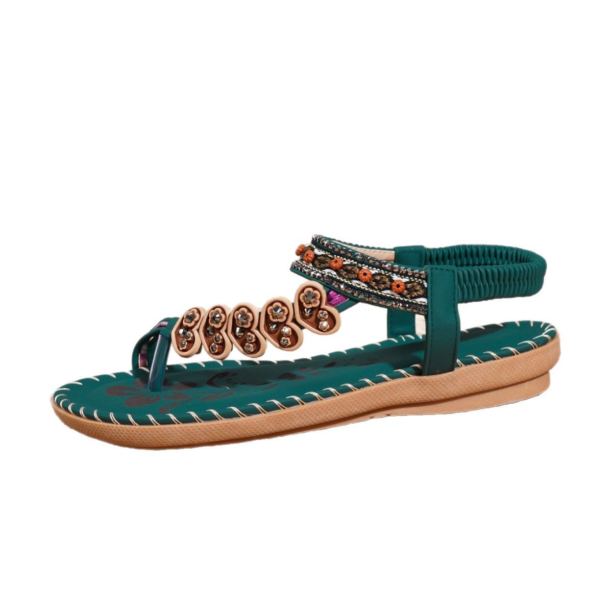 Teal sandal with decorative straps on a white background