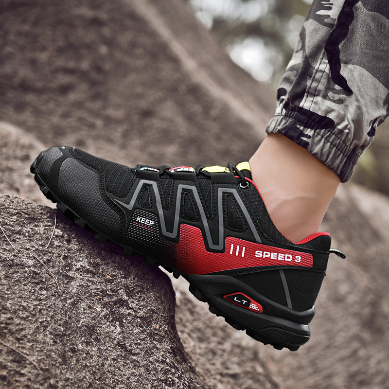 Black and red hiking shoe with 'Speed 3' branding on a rocky surface.