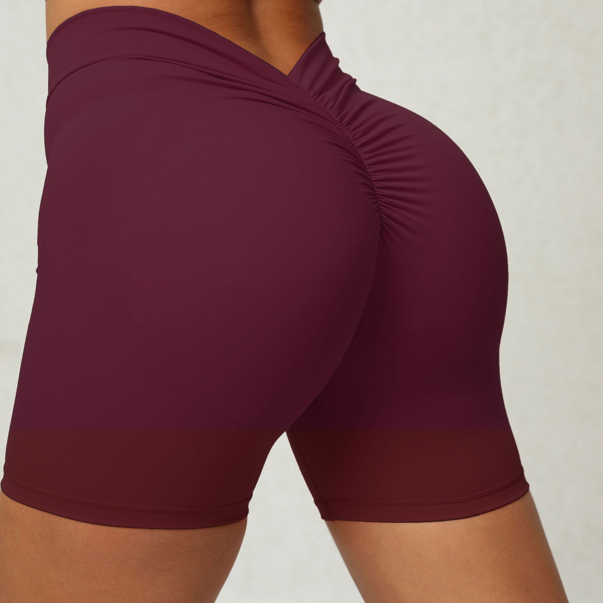 Maroon athletic shorts on a neutral background