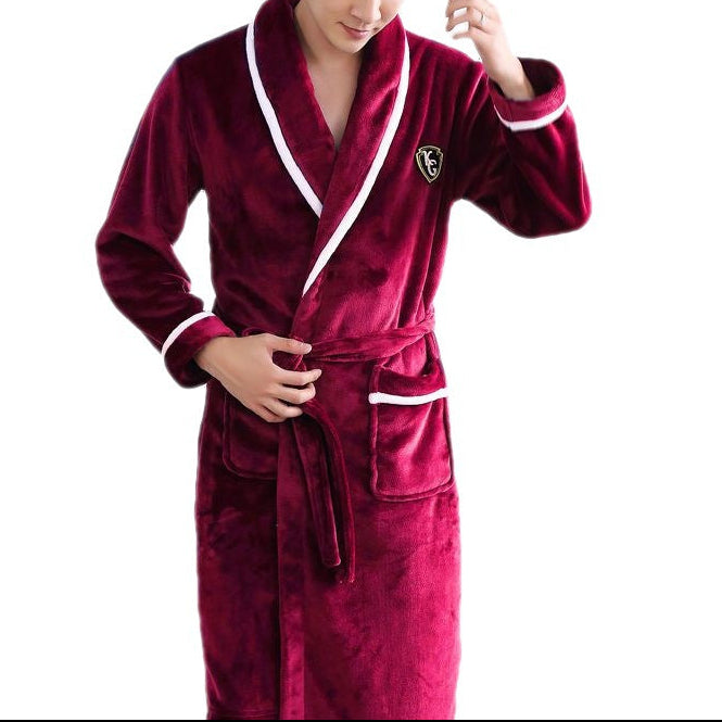Man wearing a burgundy robe with white trim on a white background