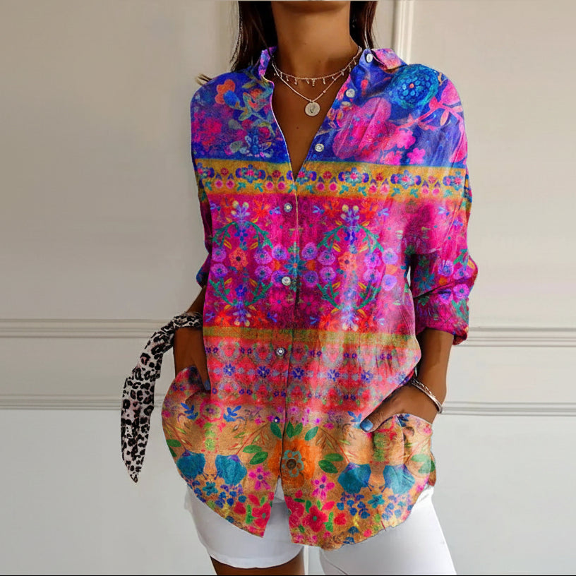 Colorful floral patterned shirt worn by a person against a neutral background