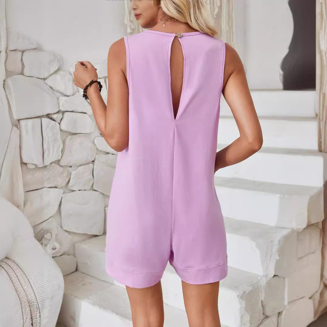 Woman wearing a light purple sleeveless dress with a cutout back, standing against a stone wall.