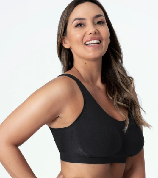 Woman wearing a black sports bra on a white background