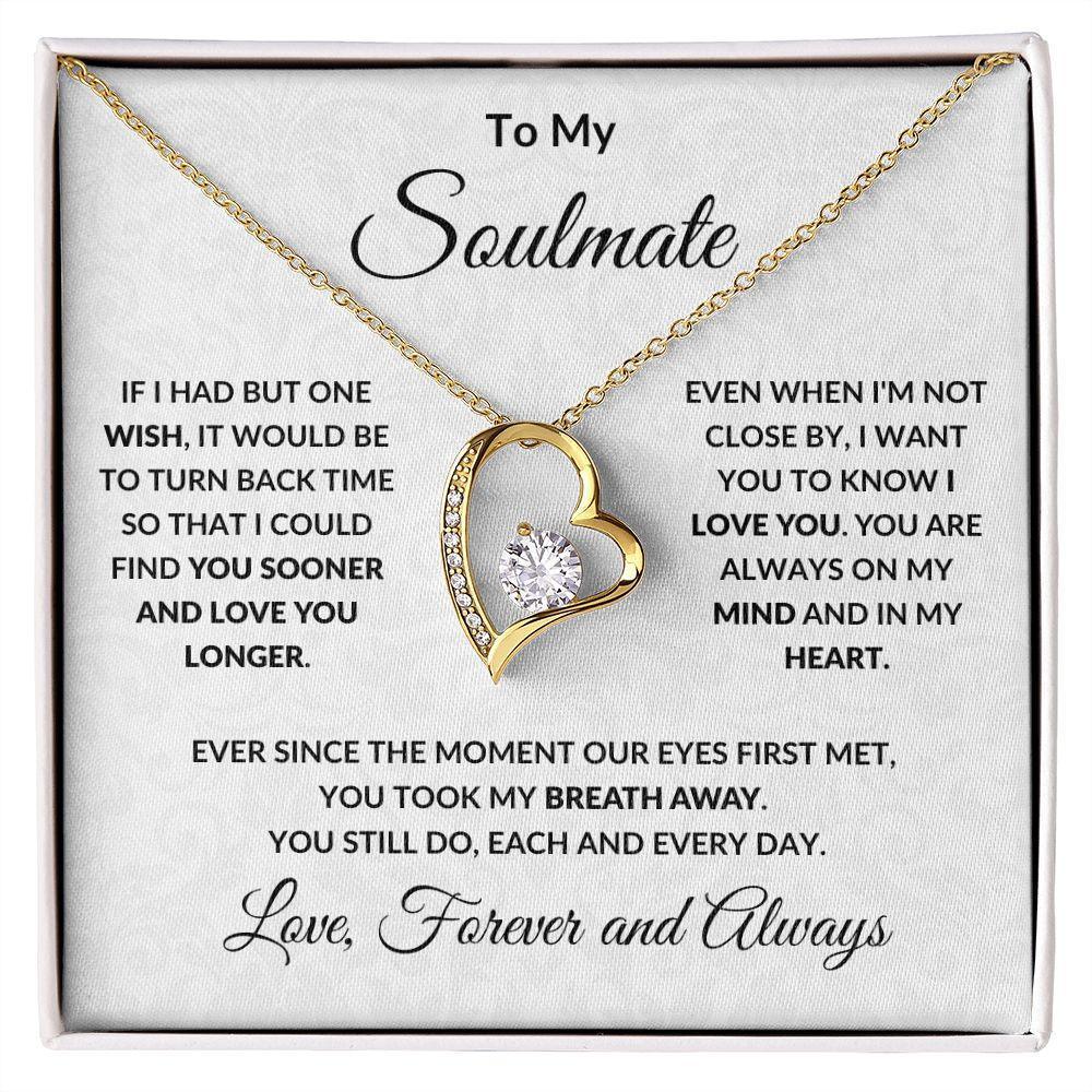 Gold heart-shaped necklace with a diamond in a box with sentimental text.