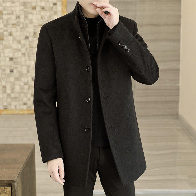 Man wearing a black coat in an indoor setting